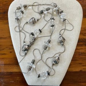 90” long strand of crystal style shapes and silver like hearts.
